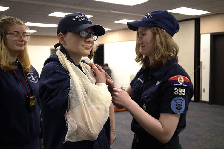 Madelyn "helps" Kenni at the first aid event