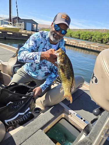 Pete Collier from Portland returns his catch to the live well.jpg