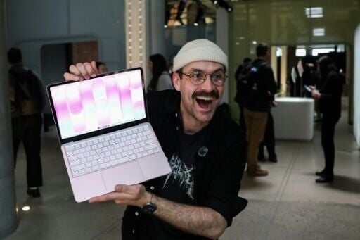 A man holds Apple's newly released MacBook Neo