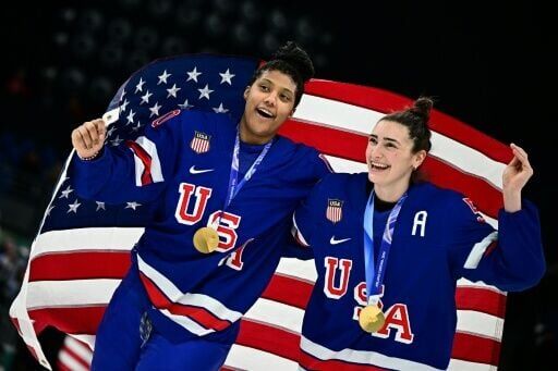 US players celebrate after winning the women's ice hockey final at the Milan-Cortina Olympics
