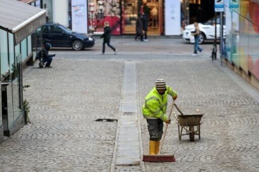 Thankless: a foreign worker sweeps a street in central Zagreb