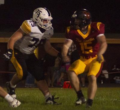 Bryson Cates (15) runs by an opposing lineman in a game earlier this year.  F. Martin Gibson photo