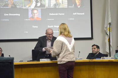 Mayor Richard Mays presents an award to Izetta Grossman