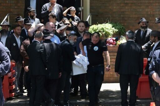 Mourners carry the coffin of 10-year-old Matilda into a waiting hearse after her funeral in Sydney. Matilda was the youngest victim of the Bondi Beach mass shooting.