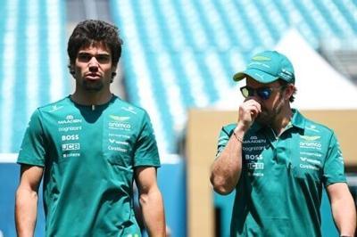 Good vibrations: Aston Martin drivers Lance Stroll and Fernando Alonso walk in the paddock before the Miami Grand Prix