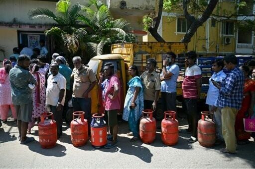 People queue to buy liquefied petroleum gas (LPG) cylinders for domestic use in Chennai on March 11, 2026