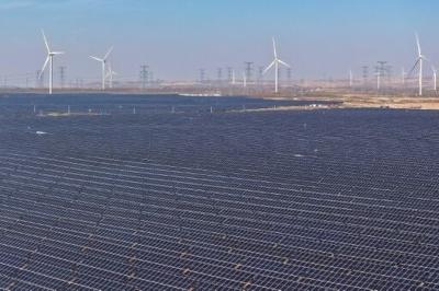 Wind turbines and solar panels -- key to the world's geen energy transition -- are seen at a solar photovoltaic farm in Lingwu in China's northern Ningxia region