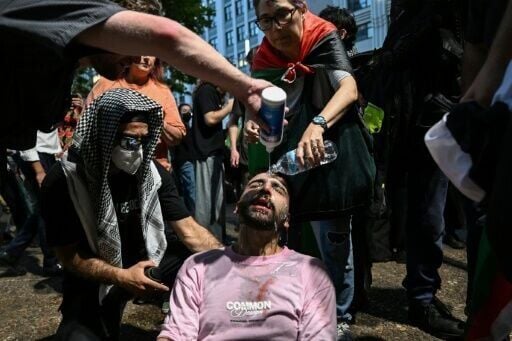 A protester is helped after police deployed pepper spray to disperse demonstrators taking part in a Pro-Palestinian rally against Israeli President Isaac Herzog's visit to Australia in Sydney on February 9, 2026