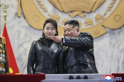 This picture taken on February 25, 2026 and released by North Korea's North Korean leader Kim Jong Un and his daughter Kim Ju Ae attend a military parade to mark the end of the ruling Workers' Party congress.