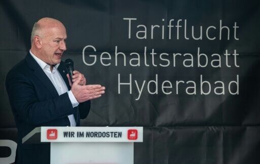 Berlin mayor Kai Wegner addresses a crowd demonstrating against BASF job cuts