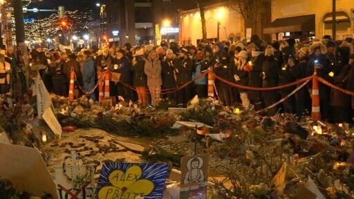 Mourners held candles as they gathered around a makeshift memorial for Pretti, who was killed Saturday by federal agents in Minneapolis