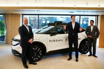 Nissan CEO Ivan Espinosa (L), Wayve Technologies CEO Alex Kendall (C) and Uber Technologies head Sarfraz Marediastand next to a prototype vehicle in Tokyo