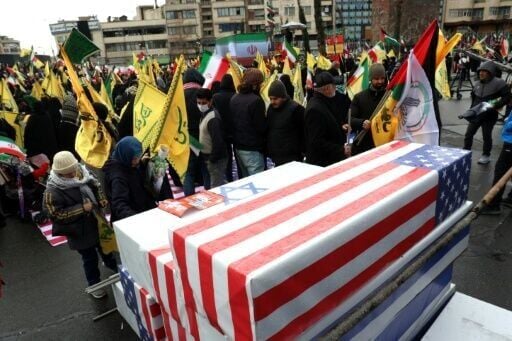 The pro-government demonstrators in Tehran piled symbolic coffins in the colours of the US and Israeli flags on each other