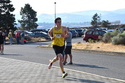 Aiden Erickson runs past spectators at a race earlier this year     Chelsea Marr photo