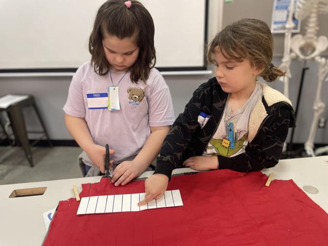 Youth work together to make no‑sew tied fleece blankets to donate to Hood River Adopt‑a‑Dog.