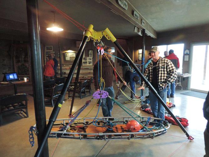 Crag Rats including Wes Mortensen (talking with John Wood) explain methods of roping and extracting patients from cliffs and crevices_file photo KNR.jpg