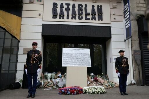 Guards flank the plaque outside the Bataclan music hall in Paris commemorating those killed in attacks in November 2025