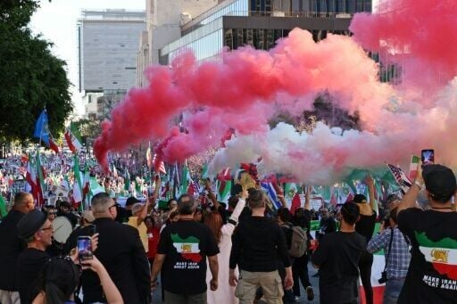 Protesters held up canisters releasing smoke in the colors of the Iranian flag during the Los Angeles rally