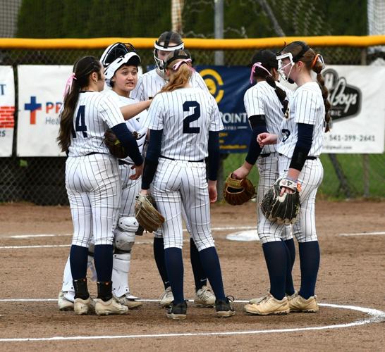 The Hood River Valley High School softball team meets during a game earlier this year.