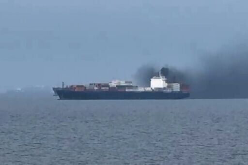 This image, taken from video footage shot by seafarer Wang Shang on Thursday, shows smoke billowing from a cargo vessel in the Gulf