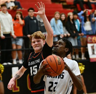 Issac Pitt (22) attacks the basket against Gladstone on Feb. 20.