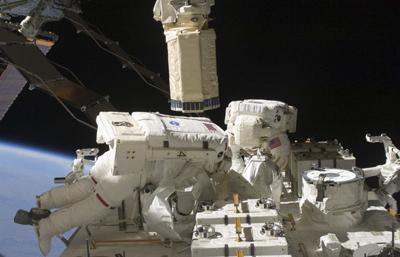 Spacewalking astronauts hunt for big station leak