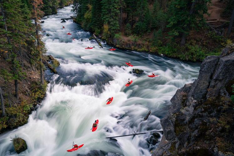 Whitewater kayaker JT Hartman sending some rapids. Long exposure photograph by Ben Kitching.