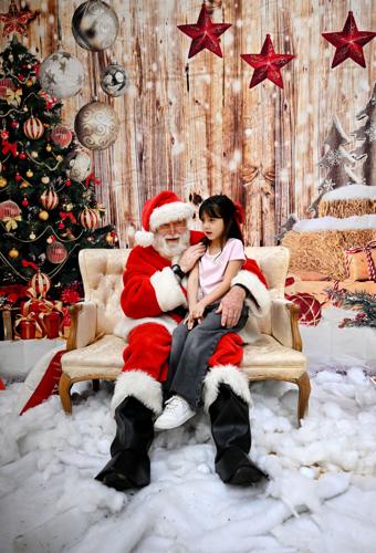 SANTA.JPGHOOD RIVER, OREGON - December 14: Santa listens to the wishes of young Aliyah Perez, 6, while seated on his chair at the Annual Last Chance Holiday Craft Show in Hood River, Oregon on December 14, 2025. The Annual Last Chance Holiday Craft Show...