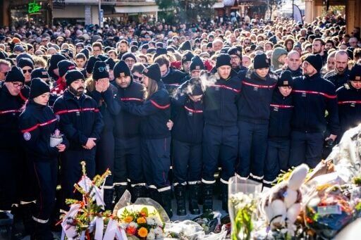 Firefighters from the Municipality of Crans-Montana gathered around a makeshift memorial to pay their respects