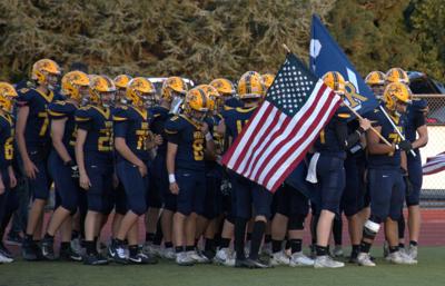 The Hood River Valley football team runs out before a game earlier this year     Zach Thummel photo