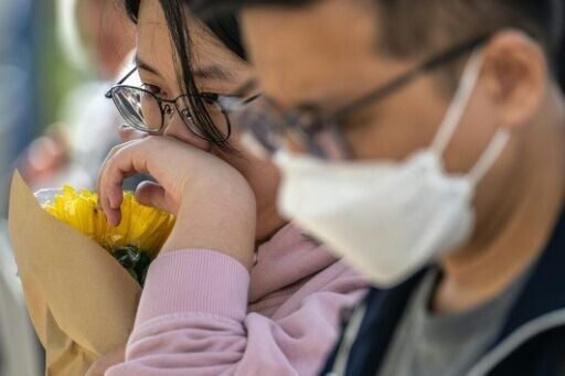People near Wang Fuk Court in Hong Kong mourning the world's deadliest residential building fire since 1980