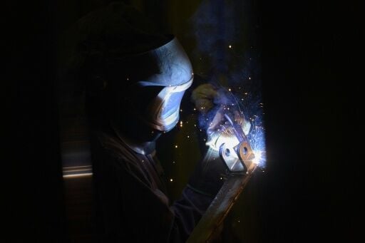 A welder works at Arctic Snowplow's factory in London, Ontario, Canada