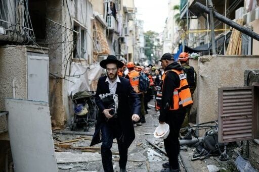 Residents and first responders at the scene following an Iranian strike in Bnei Brak in central Israel on Wednesday