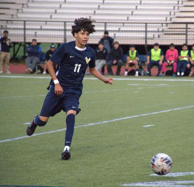Junior Anthony Hernandez (11) dribbles the ball last year.