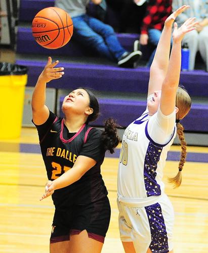 Freshman Riverhawk, Anuhea Peters (#21), gets past Astoria's Sofia Nygaard(#10) and sinks the lay-up on Saturday afternoon at Astoria High School.