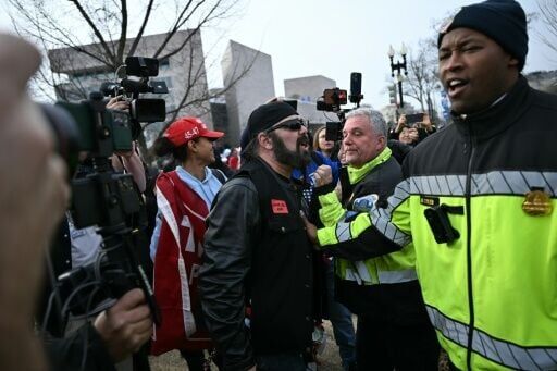 Law enforcement separate counter protestors as they clash with participants as they march to the US Capitol