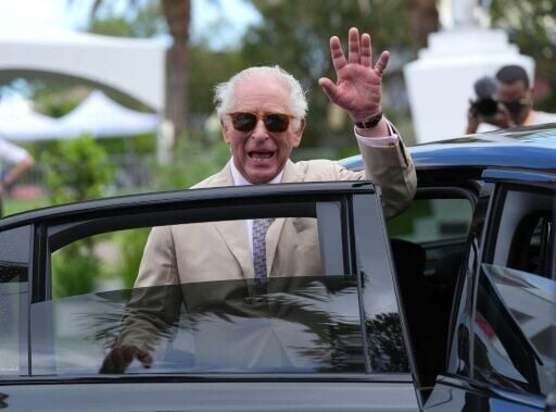 Britain's King Charles III waves goodbye after a visit to the City Hall and Arts Centre in Hamilton, Bermuda