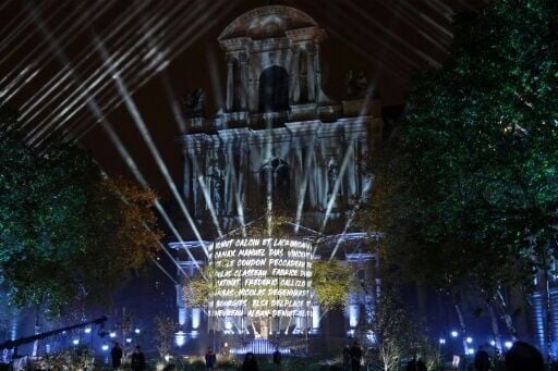 At a ceremony in central Paris, first responders slowly read out the names of those killed that Friday night