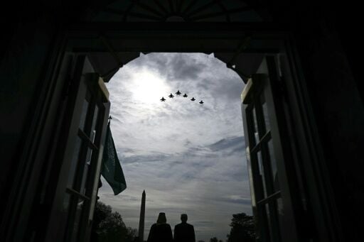 US President Donald Trump and Crown Prince and Prime Minister of the Kingdom of Saudi Arabia Mohammed bin Salman watch a flyover of military aircraft on the South Lawn at the White House in Washington, DC on November 18, 2025.
