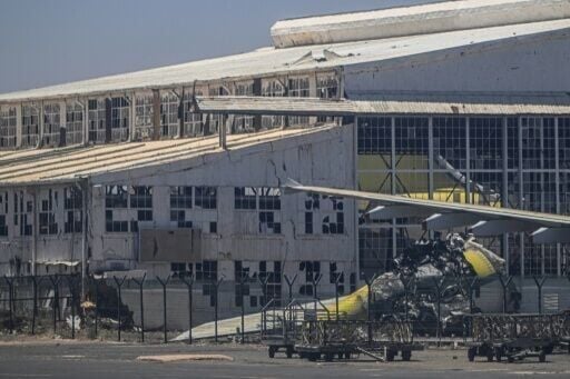 The wreckage of an aircraft on the tarmac of the damaged airport in the capital Khartoum
