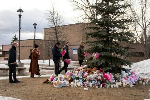 People brought flowers and paid their respects at a community vigil two days after the rural community experienced one of Canada's deadliest shootings