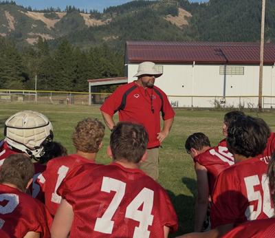 Coach John Hallead with the team earlier during summer practice.