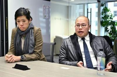 Sebastian Lai (R) and Claire Lai (L), children of jailed Hong Kong publisher and democracy activist Jimmy Lai, speak during a visit to the office of Agence France-Presse in Washington, DC on December 2, 2025