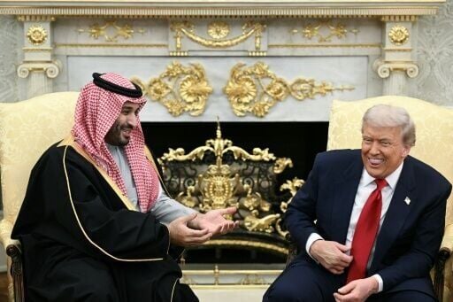 US President Donald Trump jokes about hand shakes and fist pumps with Crown Prince and Prime Minister of the Kingdom of Saudi Arabia Mohammed bin Salman