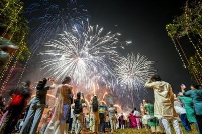 People watch fireworks light up the sky as part of Diwali celebrations in Mumbai in October