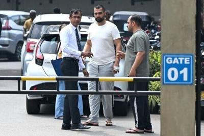 Iranian sailors talk to a hospital staffer at the Karapitiya hospital in the southern city of Galle on March 5