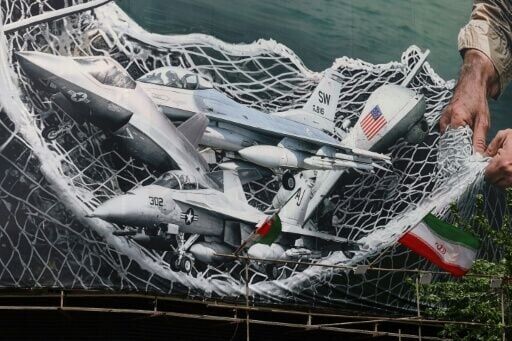 A giant billboard depicting Iranian troops using a net to catch US combat aircraft at Revolution Square in Tehran