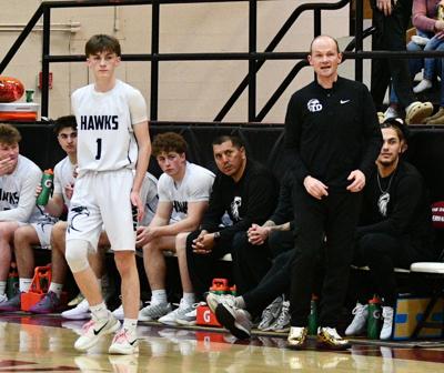 Tri-Valley Conference MVP Oliver Stevens (1) and coach Brian Stevens (right) wait for Estacada to shoot free throws earlier this year.