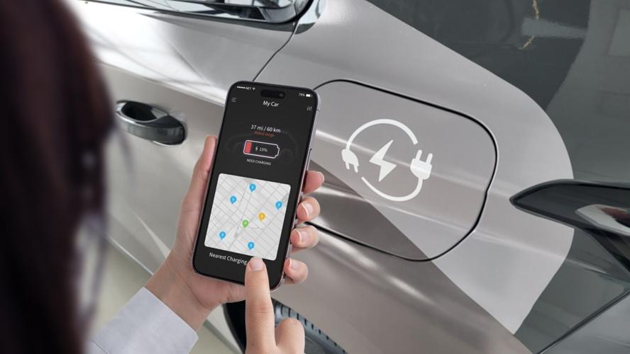 Woman,Checks,Her,Ev,App,On,A,Smartphone,,Displaying,Low