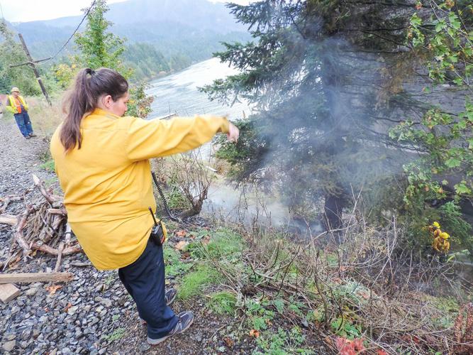 Gravity helps: In CL, firefighters use hose lowered from bridge to douse flames